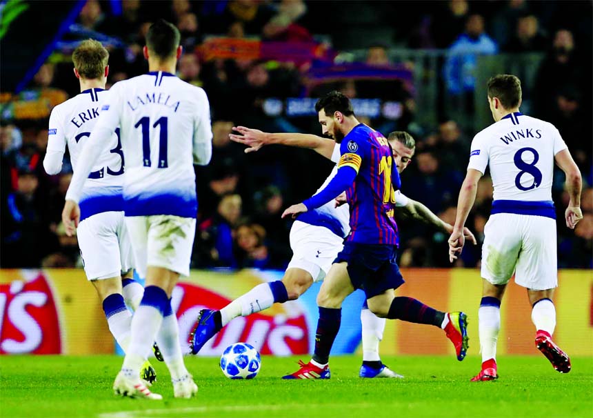 Barcelona forward Lionel Messi (center) controls the ball during the Champions League group B soccer match between FC Barcelona and Tottenham Hotspur, at the Camp Nou stadium in Barcelona, Spain on Tuesday.