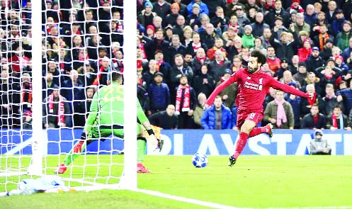 Liverpool's Mohamed Salah (right) scores his side's first goal the Champions League Group C soccer match between Liverpool and Napoli at Anfield stadium in Liverpool, England on Tuesday.