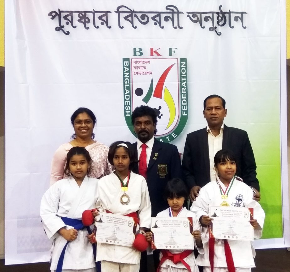 The winners of the Victory Day Kabaddi Competition with the officials of Bangladesh Karate Federation pose for photo at the Shaheed Suhrawardy Indoor Stadium in the city's Mirpur on Friday.