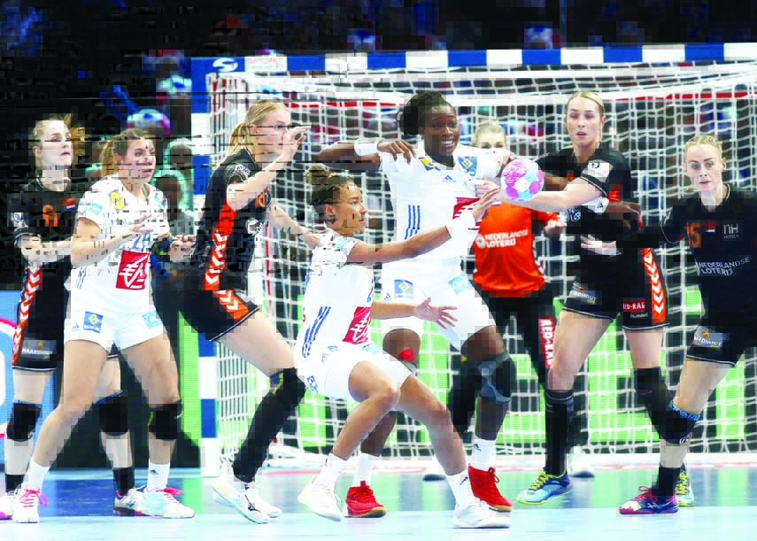 France's Estelle Nze Minko (center) gives the ball away during the Women's European Handball Championship semifinal match between Netherland and France in Paris, France on Friday.