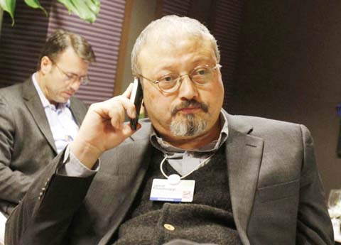 Saudi Arabian journalist Jamal Khashoggi speaks on his cellphone at the World Economic Forum in Davos, Switzerland. Saudi Arabia issued an unusually strong rebuke of the U.S. Senate on Monday, rejecting a bipartisan resolution that put the blame for the k