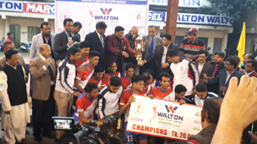 Members of Power Development Board, the champions of the Walton Victory Day Volleyball Competition with the guests and officials of Bangladesh Volleyball Federation pose for a photo session at Shaheed Nur Hossain Volleyball Stadium on Monday.