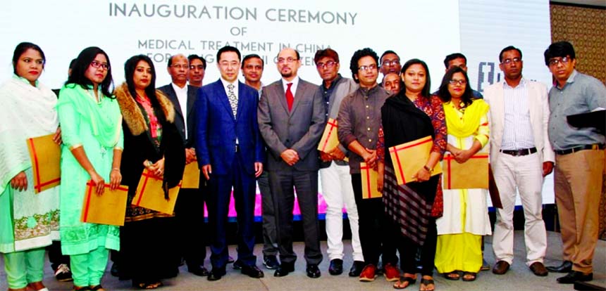 Chinese Ambassador Zhang Zuo (c) standing alongside Irving Group executives and patients at the 'Inauguration ceremony of the medical treatment in China for Bangladeshi Citizens' event at the Radisson Blu Dhaka Water Garden recently.