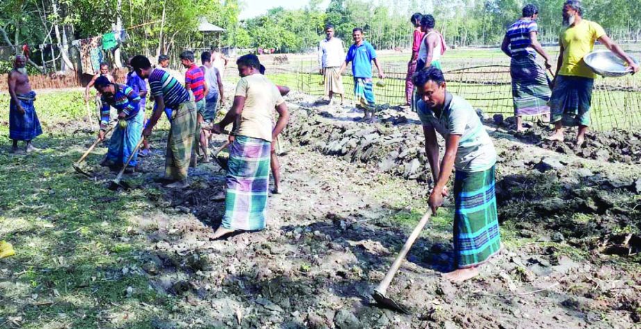 ULIPUR(Kurigram): Youths at Dalbari Village constructing a road in the village voluntarily as 70 families of the village has been suffering for want of the road from more than 30 years. This nap was taken on Monday.