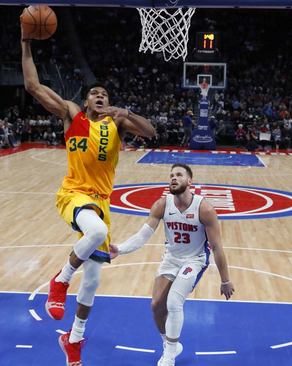 Milwaukee Bucks forward Giannis Antetokounmpo (34) dunks against Detroit Pistons forward Blake Griffin (23) in the second half of an NBA basketball game in Detroit on Monday.