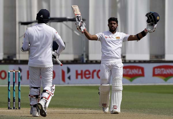 Sri Lanka's Kusal Mendis (right) celebrates with teammate Angelo Mathews after scoring a century during play on day four of the first cricket Test between New Zealand and Sri Lanka in Wellington, New Zealand on Tuesday.