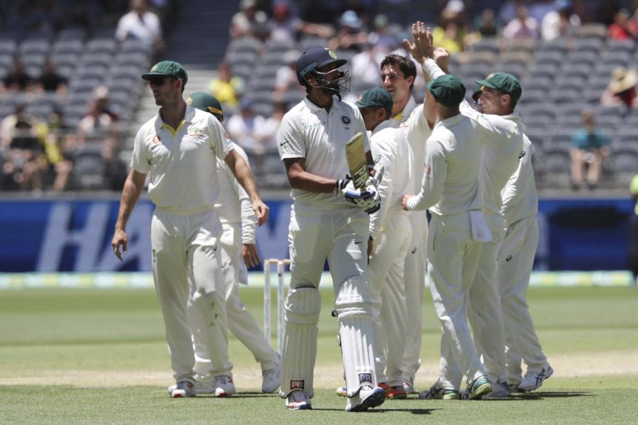 India's Ishant Sharma (center) walks off after being dismissed as Australian player celebrate during play in the second cricket Test between Australia and India in Perth, Australia on Tuesday.
