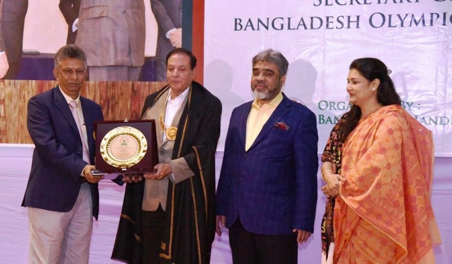 General Secretary of Bangladesh Handball Federation Asaduzzaman Kohinoor (left) handing over the crest of honour to Syed Shahed Reza, Secretary General of Bangladesh Olympic Association at the Shaheed Captain M Mansur Ali National Handball Stadium on Tues