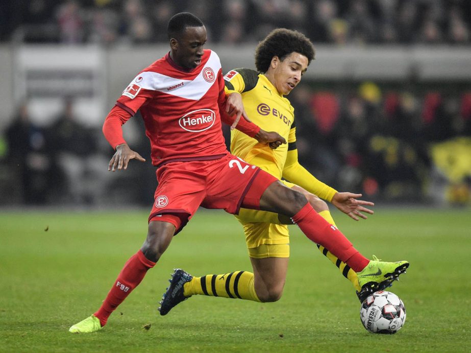 Duesseldorf's Dodi Lukebakio (left) and Dortmund's Axel Witsel challenge for the ball during the German Bundesliga soccer match between Fortuna Duesseldorf and Borussia Dortmund in Duesseldorf, Germany on Tuesday.