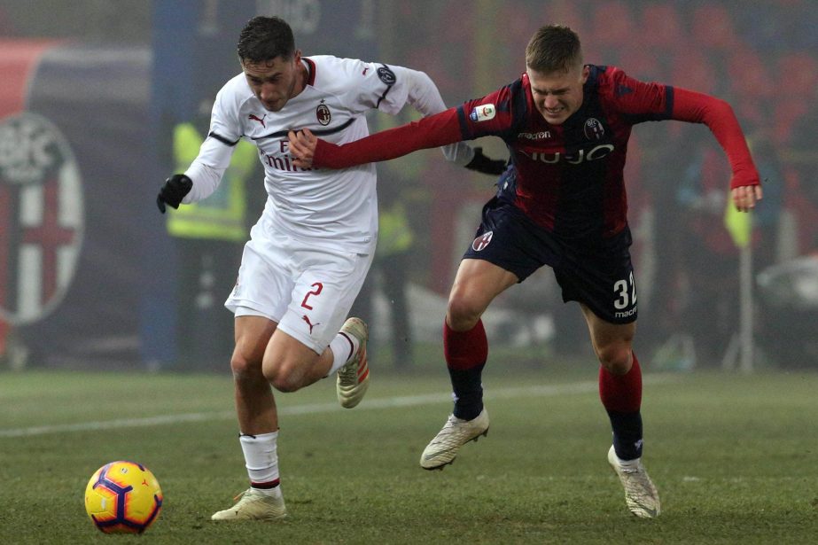 Milan's Davide Calabria (left) and Bolognas Mattias Svanberg in action during the Italian Serie A soccer match between Bologna and Milan at "Dall'Ara" stadium in Bologna, Italy on Tuesday.