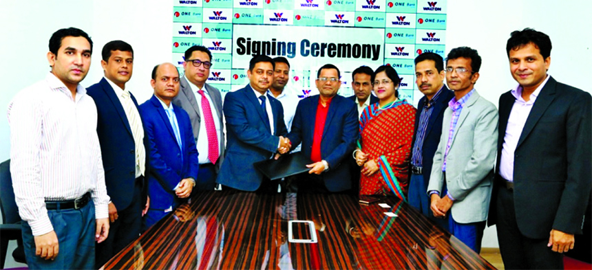 Md. Kamruzzaman, Head of Retail Banking of ONE Bank Limited (OBL) and Md. Nazrul Islam Sarker, Executive Director of Walton Plaza, exchanging a MoU signing document at the plaza recently. Under the deal, OBL Credit Cardholders will enjoy Walton products @
