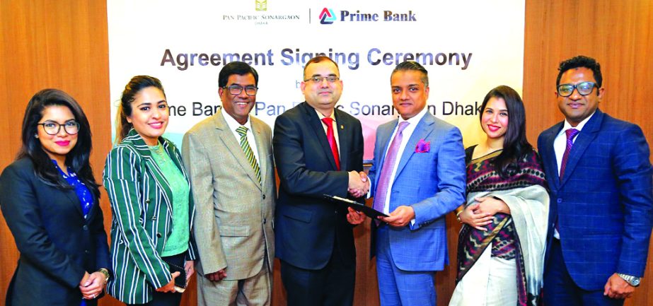 Asif Ahmed, Director (Finance) of Pan Pacific Sonargaon, Dhaka and ANM Mahfuz, Head of Consumer Banking of Prime Bank Limited, exchanging an agreement signing document at the Banks head office in the city recently. Under the deal, the hotel will allow the