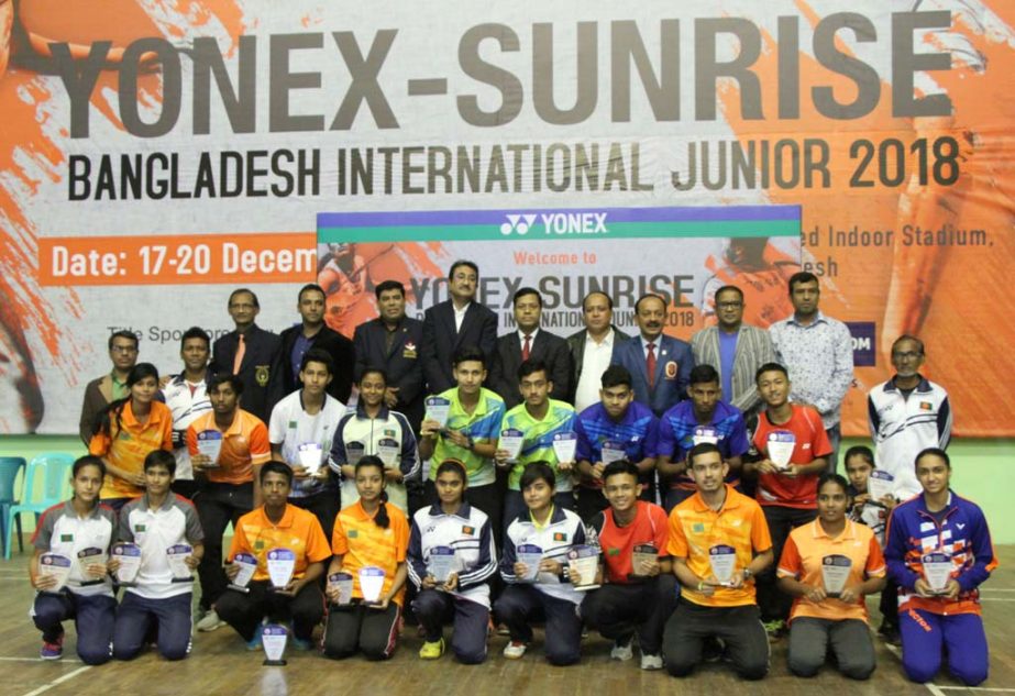 The winners of the Yonex-Sunrise Bangladesh International Junior Tennis Badminton Competition with the guests and officials of Bangladesh Badminton Federation pose for a photo session at the Shaheed Tajuddin Indoor Stadium on Thursday.