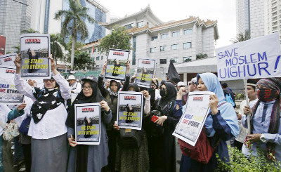 Muslim protesters rally outside China's embassy in Jakarta, Indonesia on Friday. .