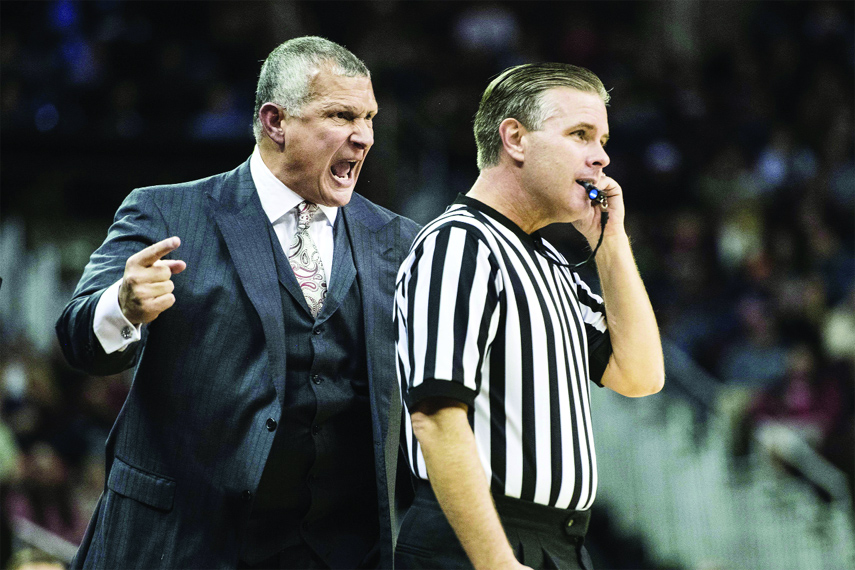 South Carolina head coach Frank Martin (left) yells at an official during the first half of an NCAA college basketball game against Virginia on Wednesday.