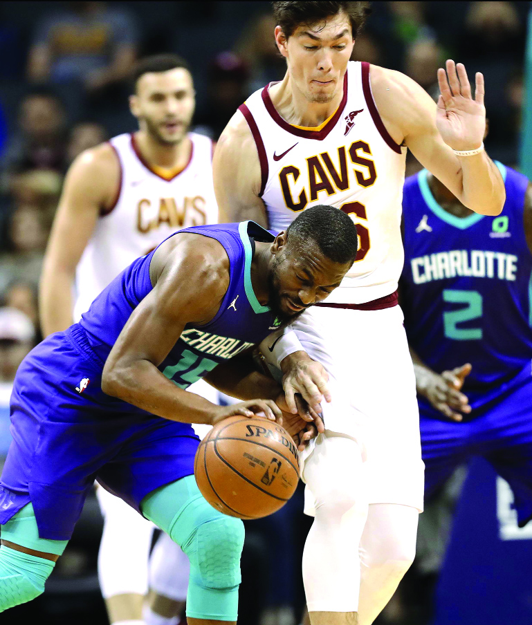 Charlotte Hornets' Kemba Walker (15) runs into Cleveland Cavaliers' Cedi Osman (16) during the first half of an NBA basketball game in Charlotte, N.C. on Wednesday.