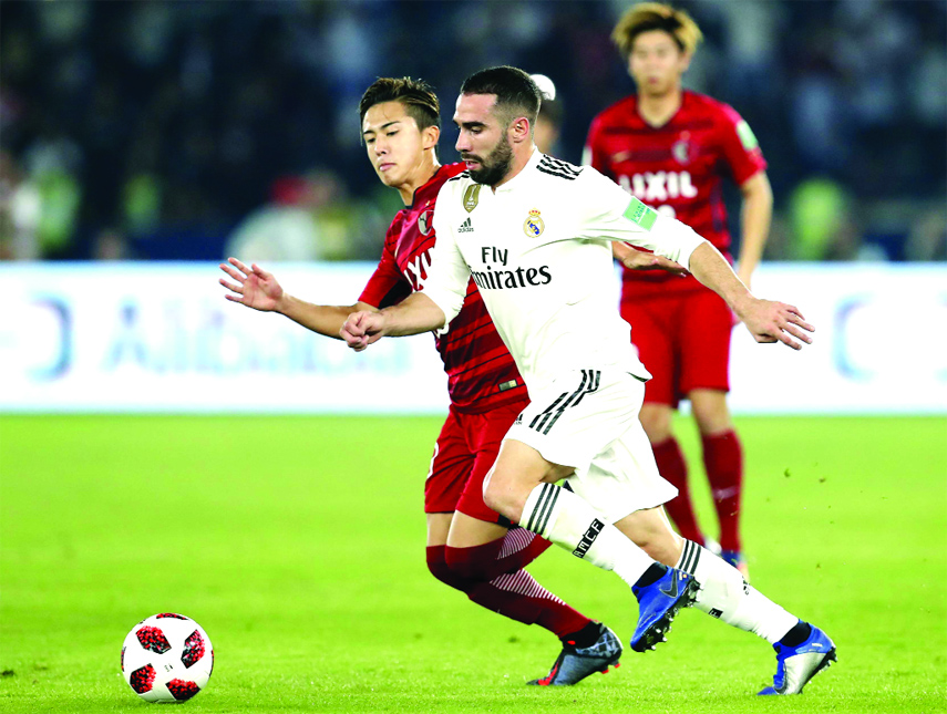 Real Madrid's defender Dani Carvajal (front) duels for the ball with Japan's Kashima Antlers Abe Hiroki during the Club World Cup semifinal soccer match between Real Madrid and Kashima Antlers at Zayed Sports City stadium in Abu Dhabi, United Arab Emira