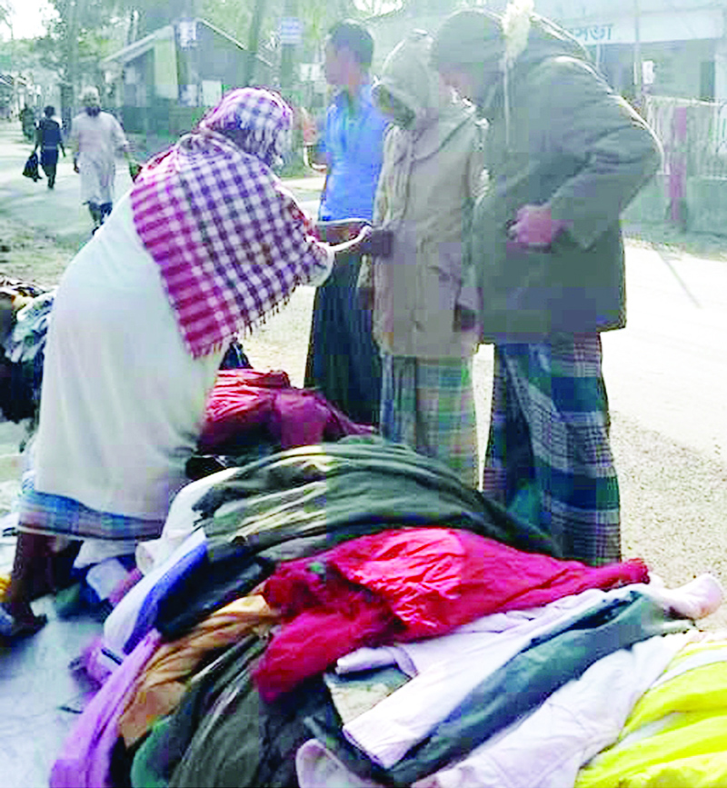 BARGUNA: People buying winter clothes from footpath market at Pathorghata Upazila due to severe cold for the few days. This picture was taken on Saturday.