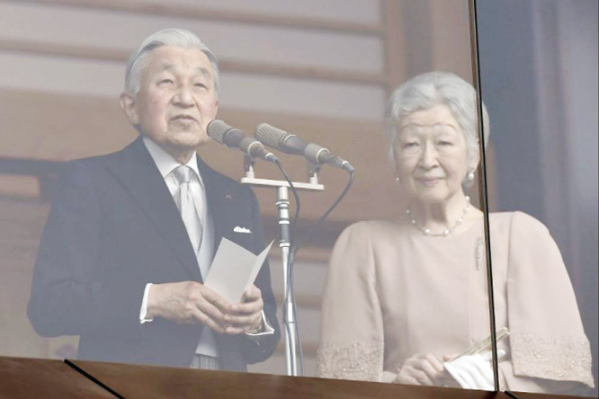 Japan's Emperor Akihito waves to well-wishers on his birthday at the Imperial Palace on Sunday.