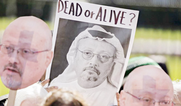 Demonstrators hold photographs of journalist Jamal Khashoggi outside the White House.