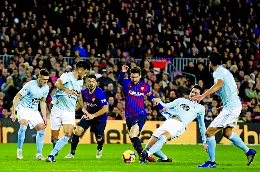FC Barcelona's Lionel Messi (center) controls the ball during the Spanish La Liga soccer match between FC Barcelona and Celta Vigo at the Camp Nou stadium in Barcelona, Spain on Saturday.
