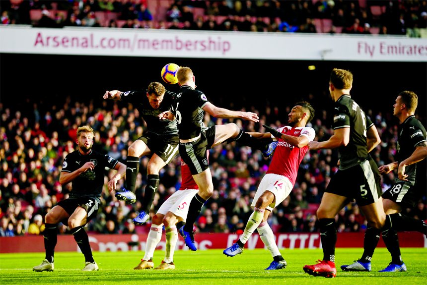 Burnley's Chris Wood (second left) heads the ball during the English Premier League soccer match between Arsenal and Burnley at the Emirates Stadium in London on Saturday.