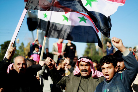 Syrian demonstrators in the northeastern Syrian Kurdish-majority city of Qamishli asking for the Syrian army's protection as Turkey threatens to carry out a fresh offensive following the US move to withdraw.