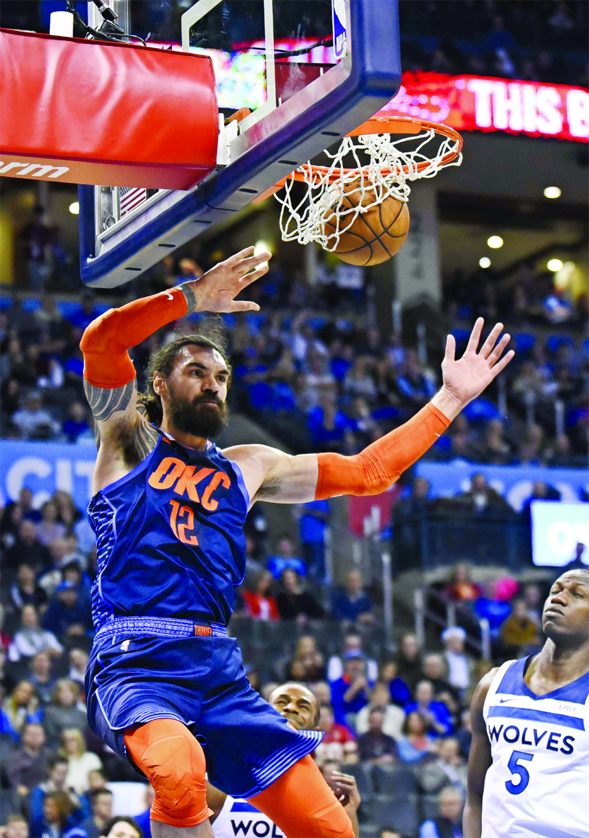 Oklahoma City Thunder center Steven Adams (12) dunks in the second half of an NBA basketball game against the Minnesota Timberwolves in Oklahoma City on Sunday.