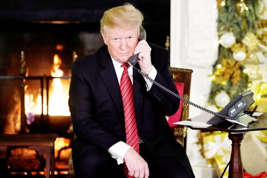US President participates in NORAD Santa tracker phone calls from the White House in Washington on Monday.