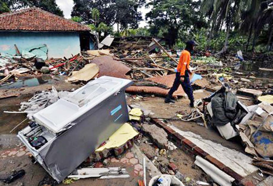 A rescue worker walks as he searches for victims among debris after a tsunami hit Sunda Strait at Carita district in Pandeglang, Indonesiaon Tuesday.