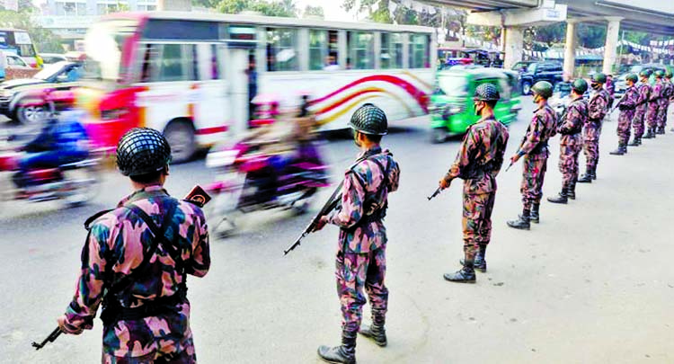 BGB members stand guard in the city roads for security measures on the occasion of the 11th parliamentary elections. The snap was taken from the city's Satrasta intersection, Tejgaon on Wednesday.