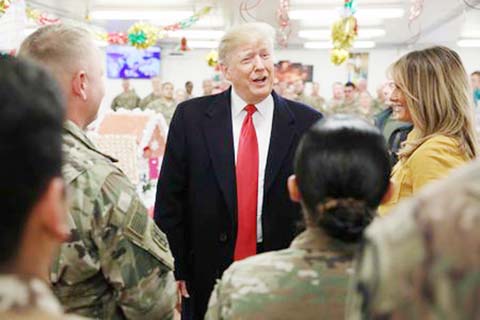 US President Donald Trump and First Lady Melania Trump greet military personnel at the dining facility during an unannounced visit to Al Asad Air Base, Iraq.