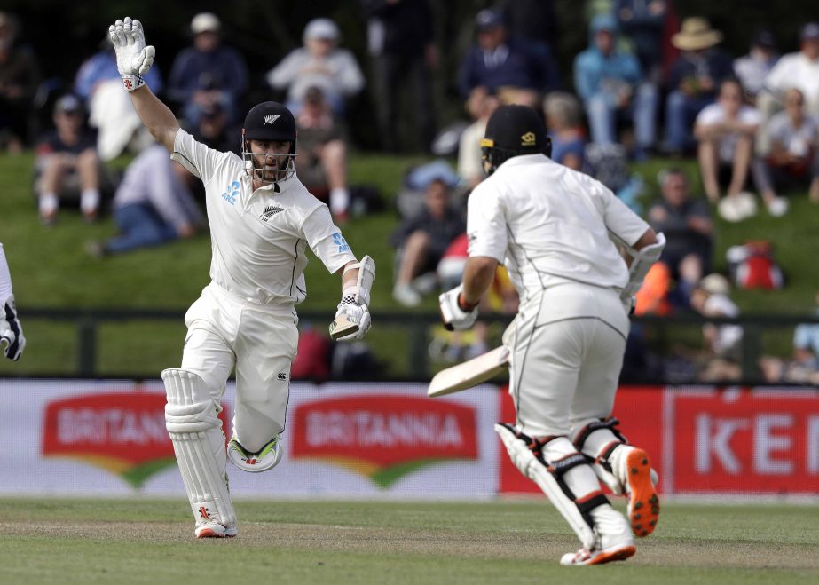 New Zealand's Kane Williamson reacts as he runs towards teammate Tom Latham during play on day two of the second cricket Test between New Zealand and Sri Lanka at Hagley Oval in Christchurch, New Zealand on Thursday.