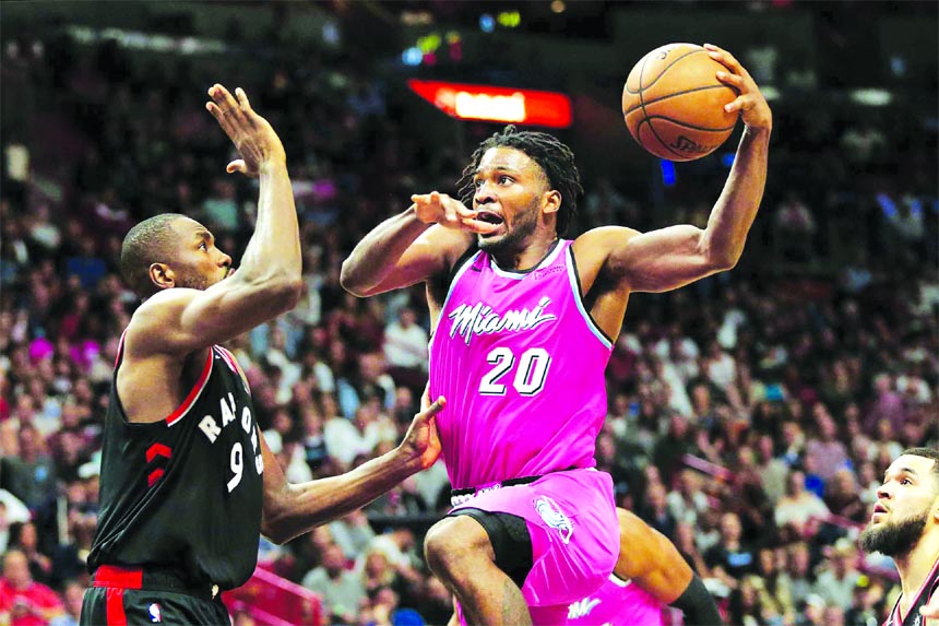 Miami Heat forward Justise Winslow (20) drives to the basket against Toronto Raptors forward Serge Ibaka (9) during the second half of an NBA basketball game on Wednesday in Miami. Toronto defeated Miami 106-104.