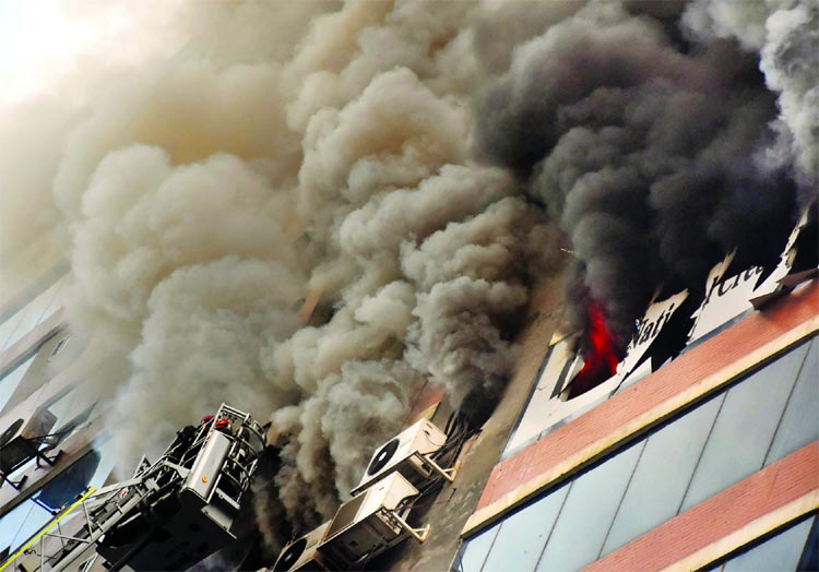 Firefighters extinguishing the fire broke out at city's Zaman Tower in Purana Palton on Friday.