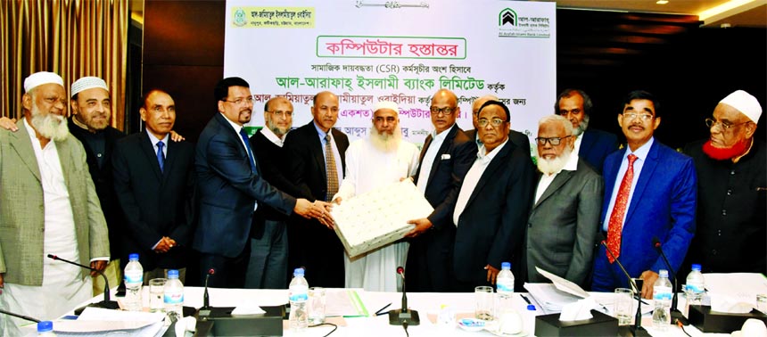 Abdus Samad Labu, Chairman of Al-Arafah Islami Bank Limited, handing over 100 computer sets under CSR programme to Salahuddin, Principal of Jamia Islamia Ubaidia Nanupur Madrasa of Fatikchhari, Chattogram at a hotel in Chattogram recently. Farman R Chowdh