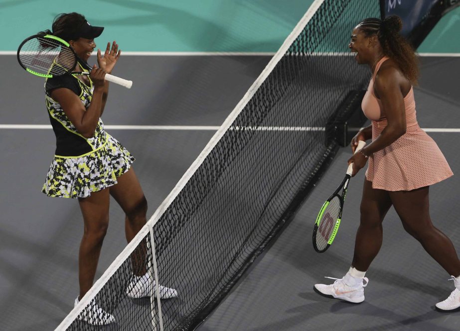 Venus Williams (left) from the U.S., celebrates after defeating her sister, Serena in a match during the opening day of the Mubadala World Tennis Championship in Abu Dhabi, United Arab Emirates on Thursday.