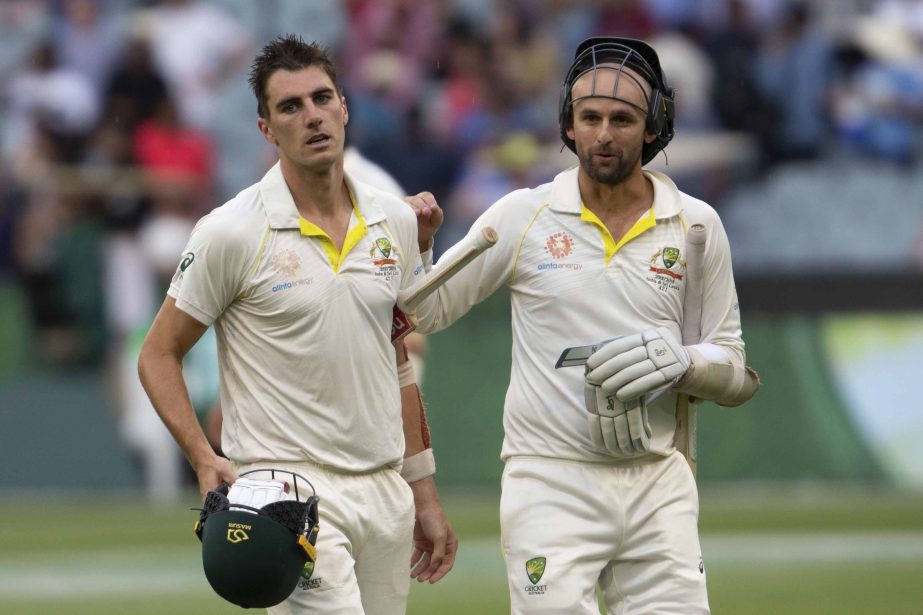 Australia's Pat Cummins (left) and Nathan Lyon walk off the field at the end of play of day four of the third cricket Test between India and Australia in Melbourne, Australia on Saturday.