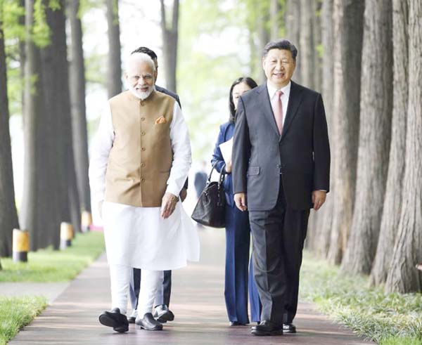 Indian Prime Minister Narendra Modi, left, and Chinese President Xi Jinping walk together in Wuhan in central China's Hubei Province. AP file photo