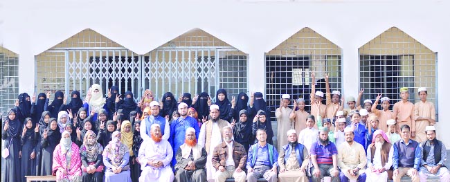 FENI: Jubilant teachers and students of Feni Aliya (Honours) Kamil Mardrasa posed for a photo session after their successful result of cent percent pass in Nurani, Ebtedayee Education Completion, and JDC on Monday.