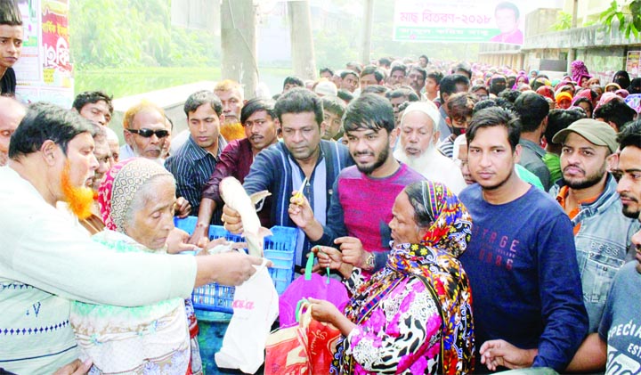 NARAYANGANJ: Abdul Karim Babu, Councillor, Ward No 17 distributing cultivated fishes among the people of Paiapara area on Monday.