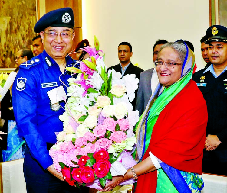 Inspector General of Police Dr Jabed Patwary greet Prime Minister and Awami League President Sheikh Hasina at Ganobhaban on Monday by giving bouquet for her party's landslide victory in the 11th parliamentary elections. BSS photo