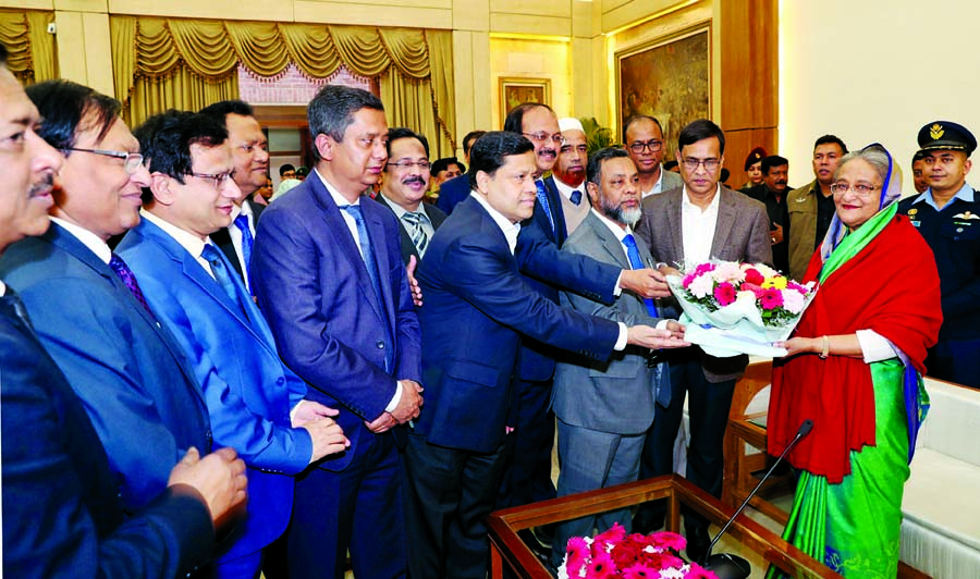 Secretaries of different ministries including Cabinet Secretary Shafiul Alam and Information Secretary Abdul Malek greet Prime Minister and Awami League President Sheikh Hasina by giving bouquet at Ganobhaban on Monday for her party's landslide victory i