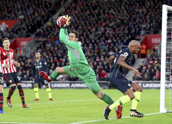 Manchester City's Vincent Kompany (right) rues a missed chance as Southampton goalkeeper Alex McCarthy gathers the ball during their English Premier League soccer match at St Mary's Stadium in Southampton, England on Sunday.