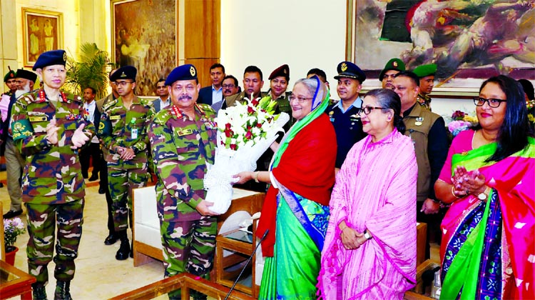 Army Chief Abdul Aziz congratulating Prime Minister Sheikh Hasina with a bouquet at Ganobhaban on her landslide victory in 11th National Election on Monday.