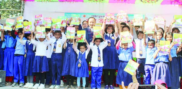 DINAJPUR (South): Primary and Mass Education Minister and newly elected MP Md Mustafizur Rahman Fizar posed for a photo session with students with new Text books in observance of the Textbook Festival at Fulbari Upazila yesterday.