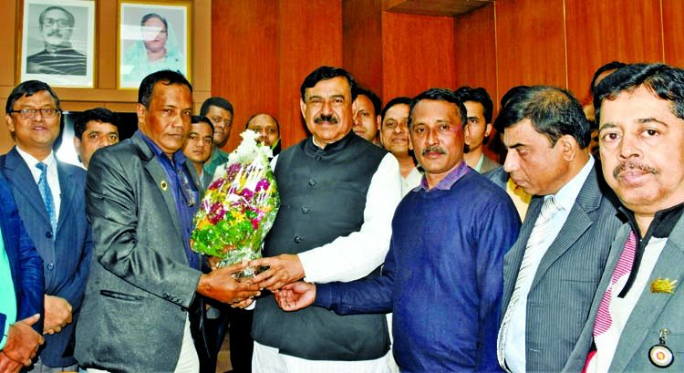 Photo journalists greet Shipping Minister Shajahan Khan by giving bouquet at his ministry on Tuesday on the occasion of New Year-2019.