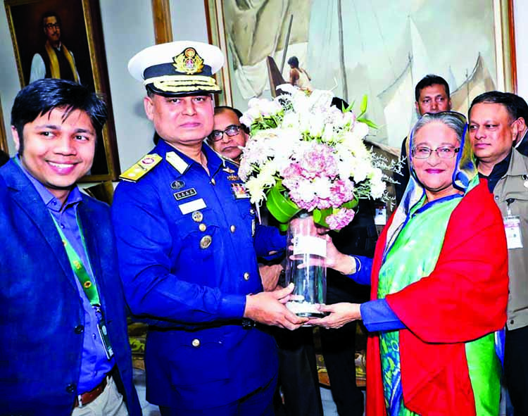 Director General of Bangladesh Coast Guard Rear Admiral AMMM Aurangzeb Chowdhury on Tuesday congratulating Prime Minister Sheikh Hasina at Ganobhaban with bouquet marking the victory of her party (Awami League) for the 3rd consecutive term and securing a