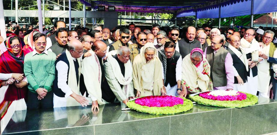 Prime Minister Sheikh Hasina paying tributes to Father of the Nation along with party leaders by placing wreaths at the portrait of Bangabandhu in front of Memorial Museum at Dhanmondi on Tuesday on the occasion of her party's absolute victory in the ele