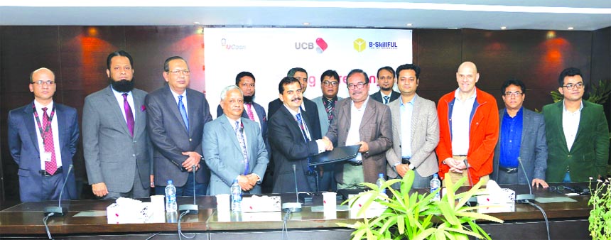 A T M Tahmiduzzaman, Executive Vice-President of United Commercial Bank Limited (UCB) and Md. Matiur Rahaman, Team leader of B-SkillFUL project of Swiss contact, exchanging a MoU signing documents on behalf of both the organizations at the Banks head offi